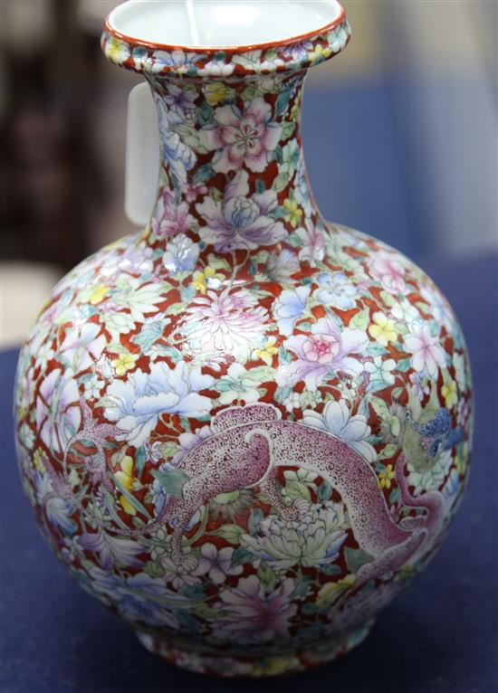 A Chinese coral ground dragon bottle vase, Qianlong seal mark, early 20th century, 19cm